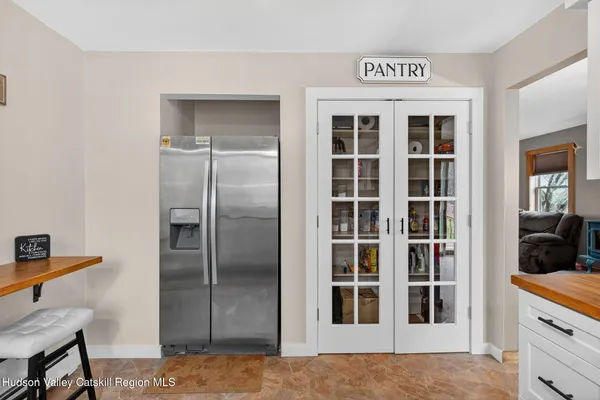 a view of a kitchen has dishwasher and refrigerator