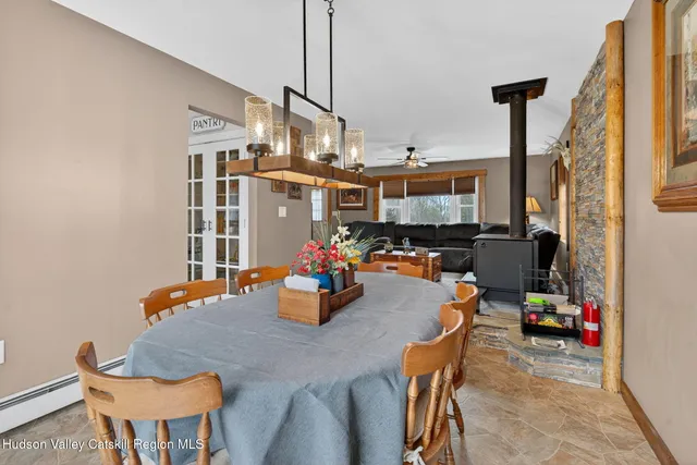 a view of a dining room with furniture and a chandelier