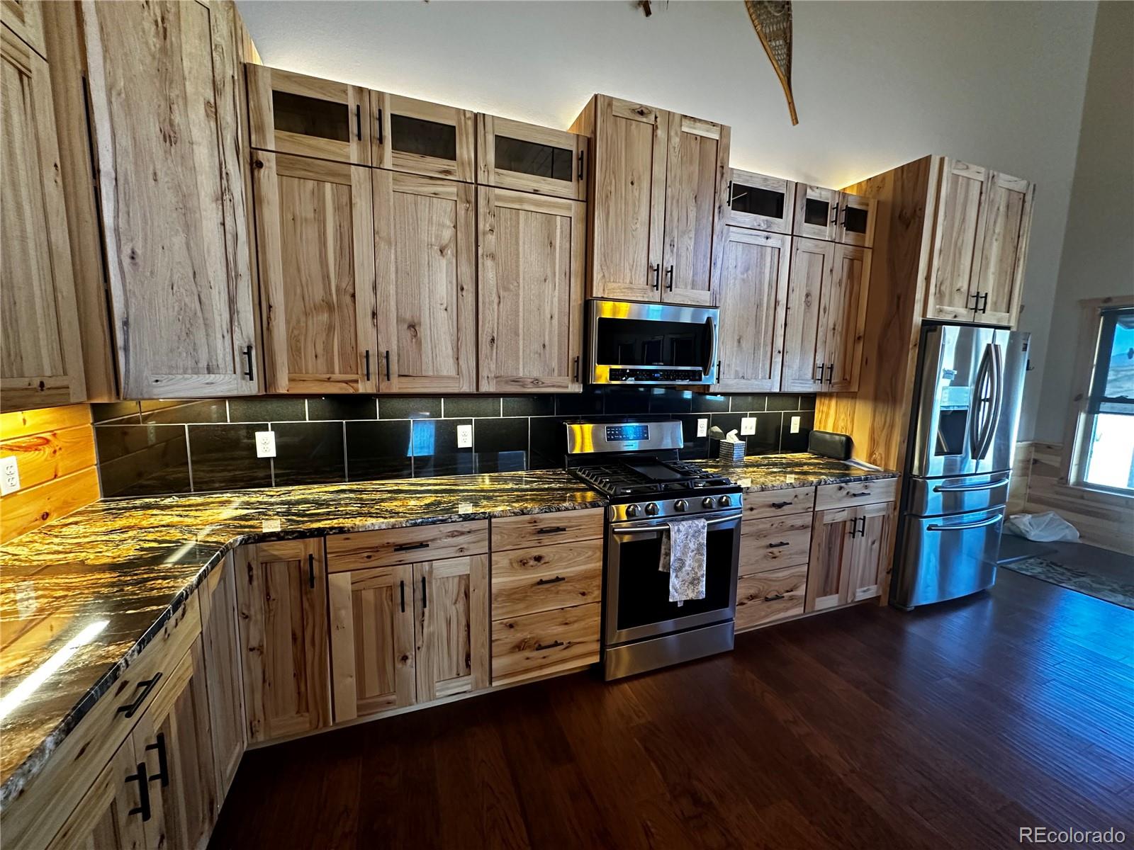 3744 Icehouse Road Fort Garland, CO 81133 - Photo 12 of 48 a kitchen with stainless steel appliances granite countertop a stove a sink and a refrigerator