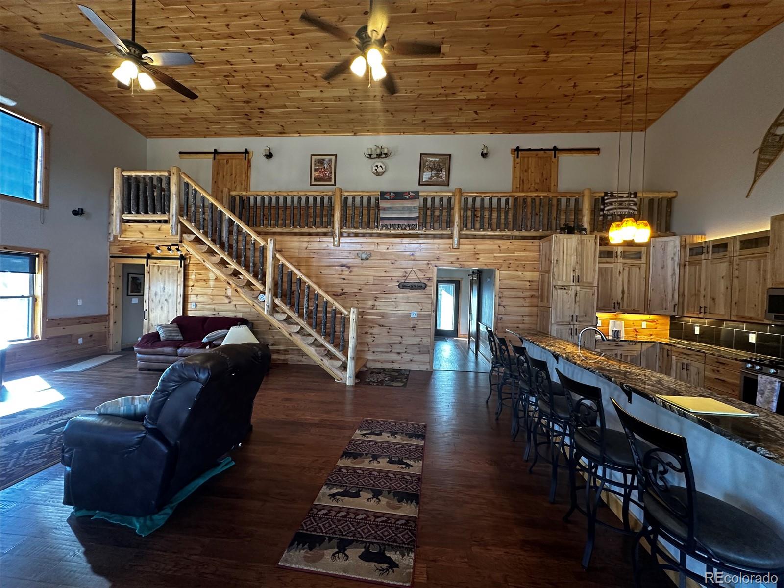3744 Icehouse Road Fort Garland, CO 81133 - Photo 16 of 48 a living room with furniture and wooden floor