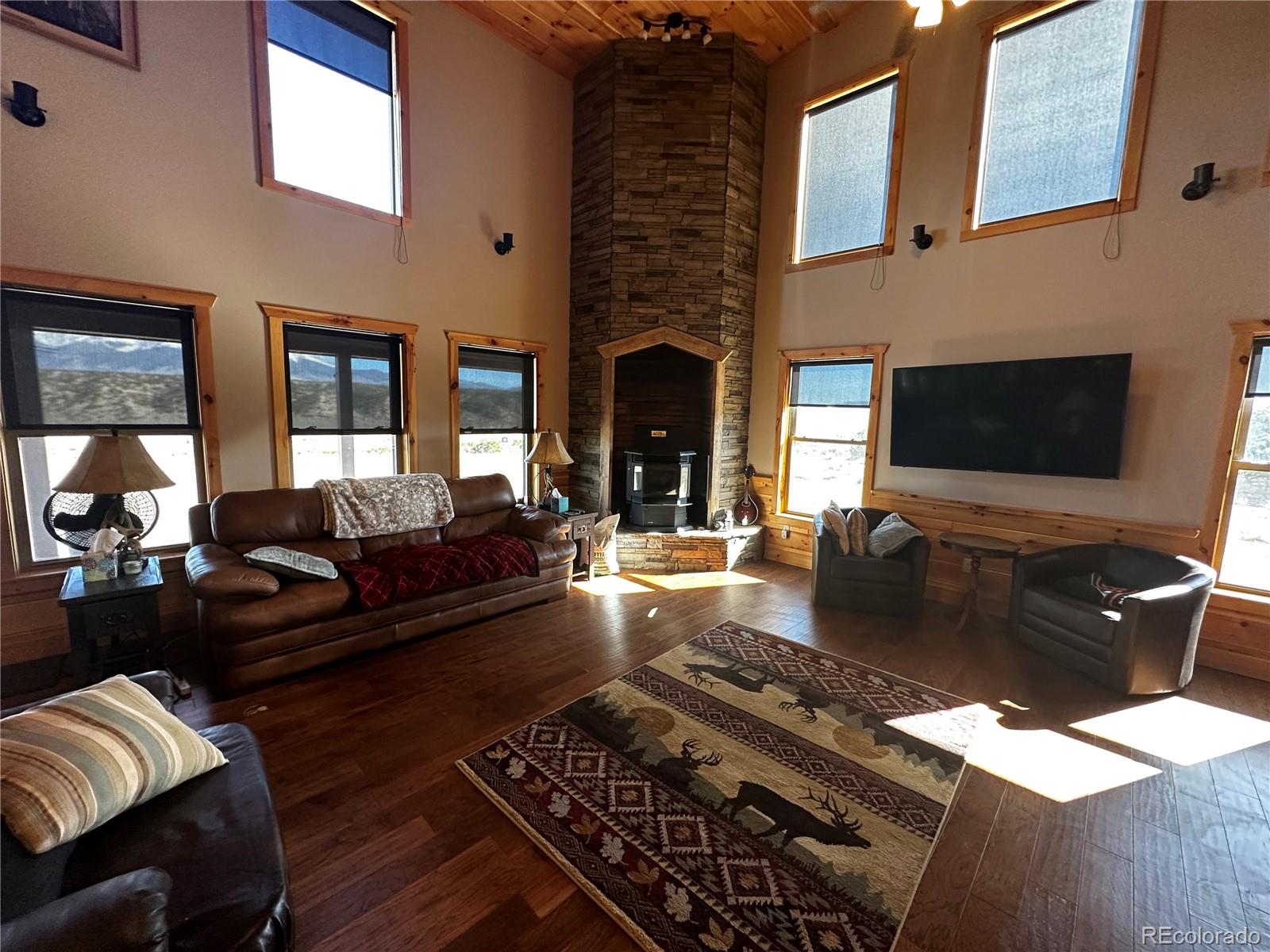 3744 Icehouse Road Fort Garland, CO 81133 - Photo 17 of 48 a living room with furniture and a fireplace