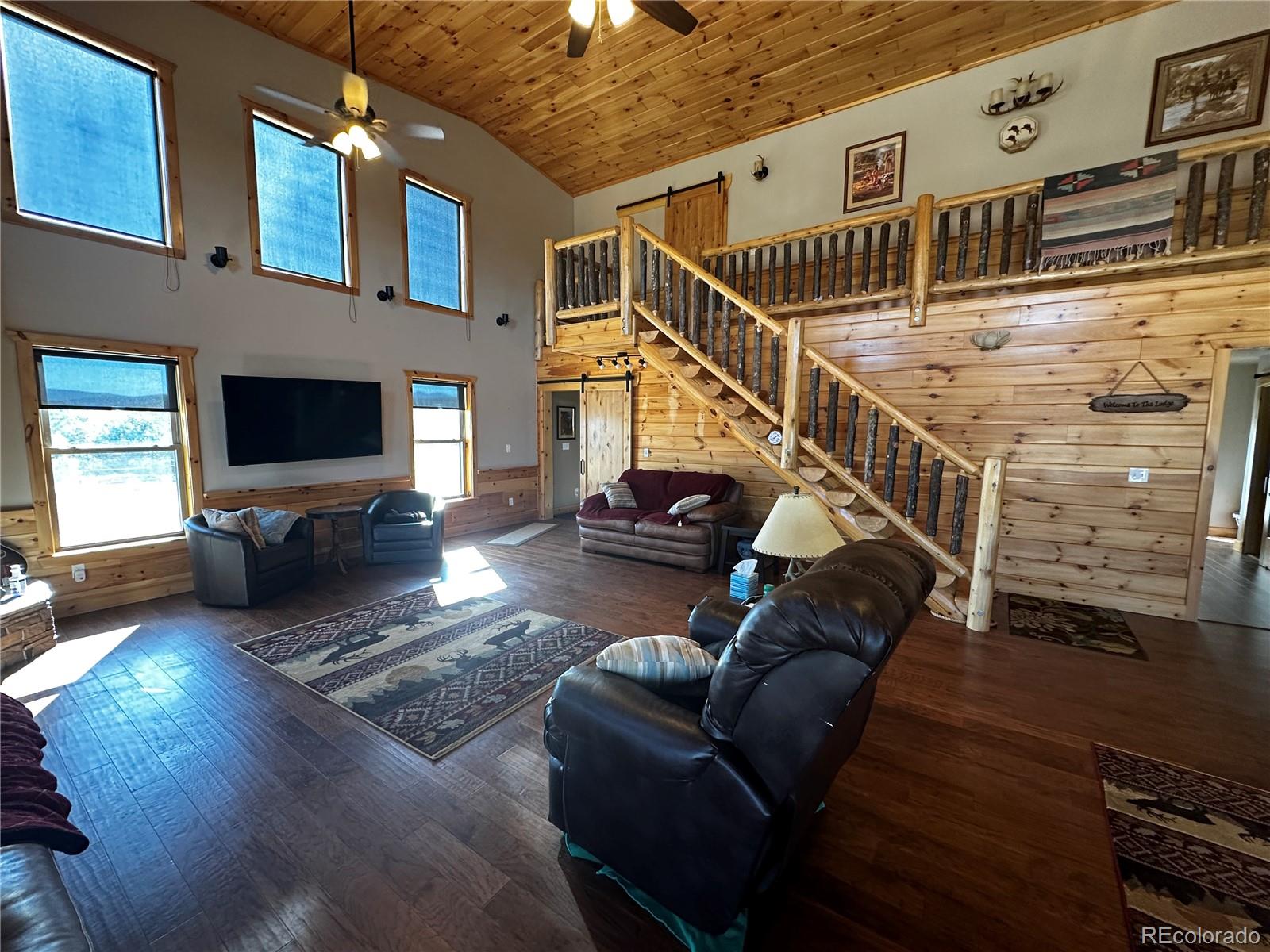 3744 Icehouse Road Fort Garland, CO 81133 - Photo 18 of 48 a living room with furniture and a flat screen tv