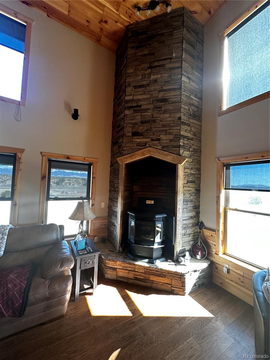 3744 Icehouse Road Fort Garland, CO 81133 - Photo 23 of 48 a living room with furniture and a fireplace