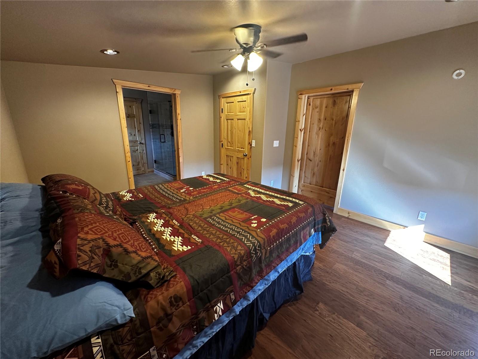 3744 Icehouse Road Fort Garland, CO 81133 - Photo 24 of 48 a bedroom with a bed and a chandelier