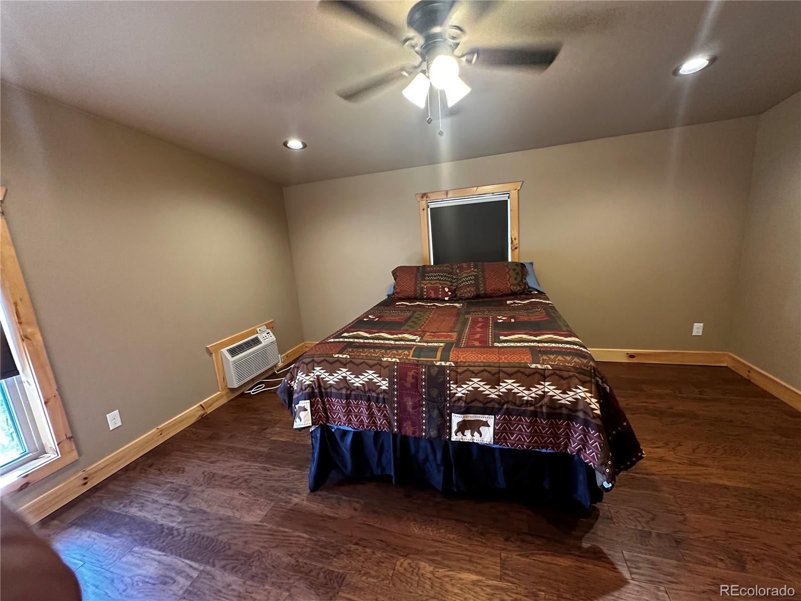 3744 Icehouse Road Fort Garland, CO 81133 - Photo 25 of 48 a bedroom with a bed and a chandelier