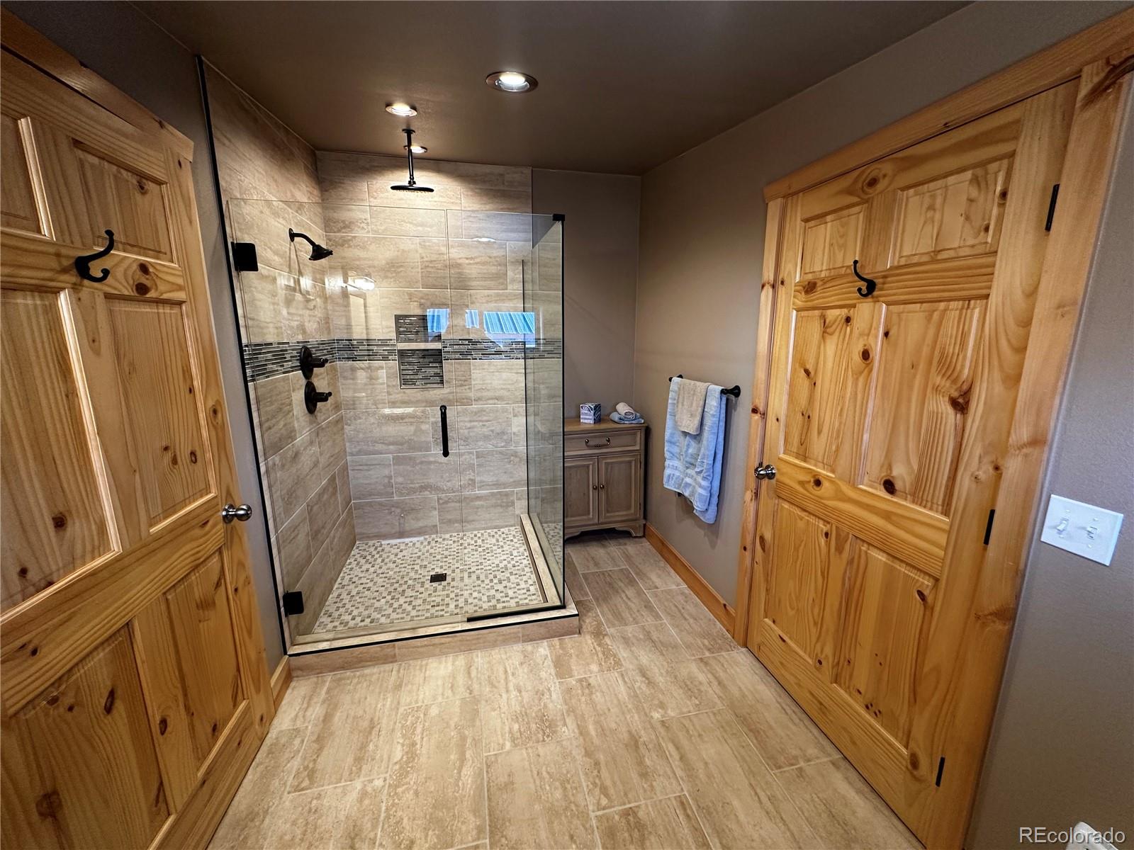 3744 Icehouse Road Fort Garland, CO 81133 - Photo 27 of 48 a bathroom with a tub shower sink and mirror