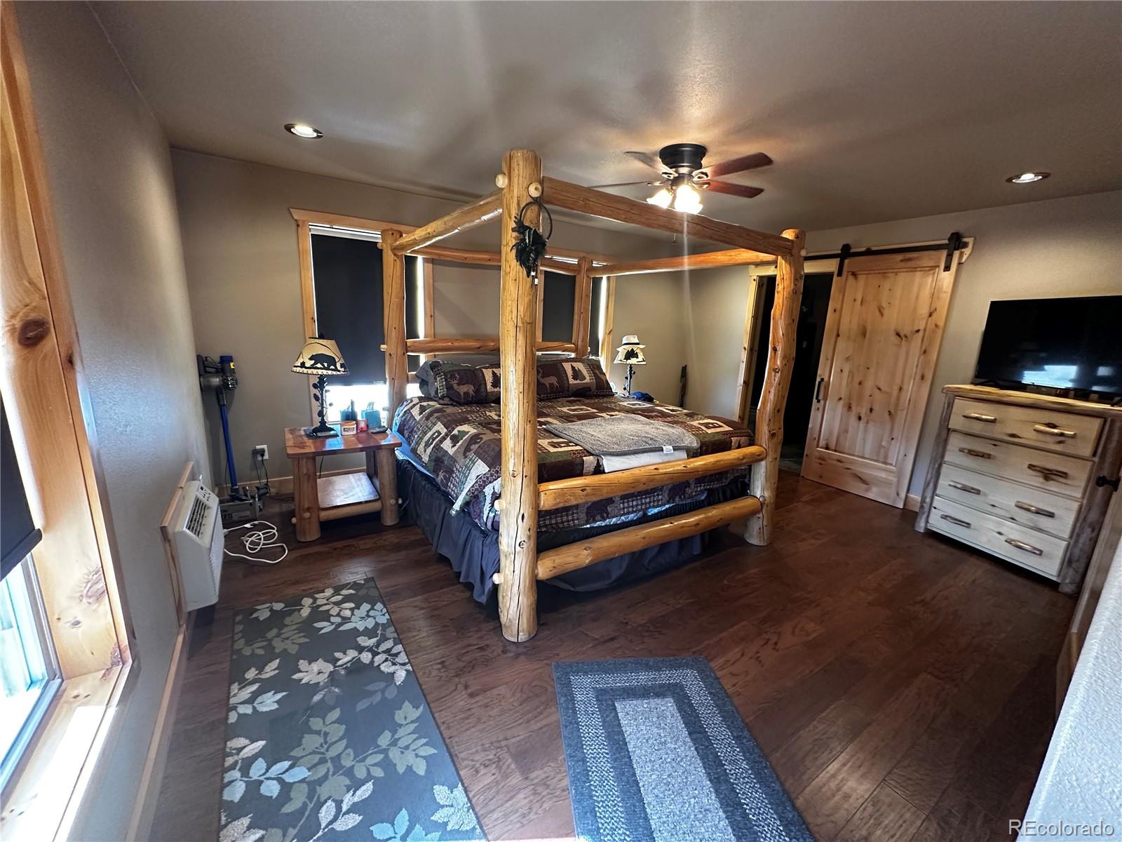 3744 Icehouse Road Fort Garland, CO 81133 - Photo 28 of 48 a bedroom with furniture and a flat screen tv