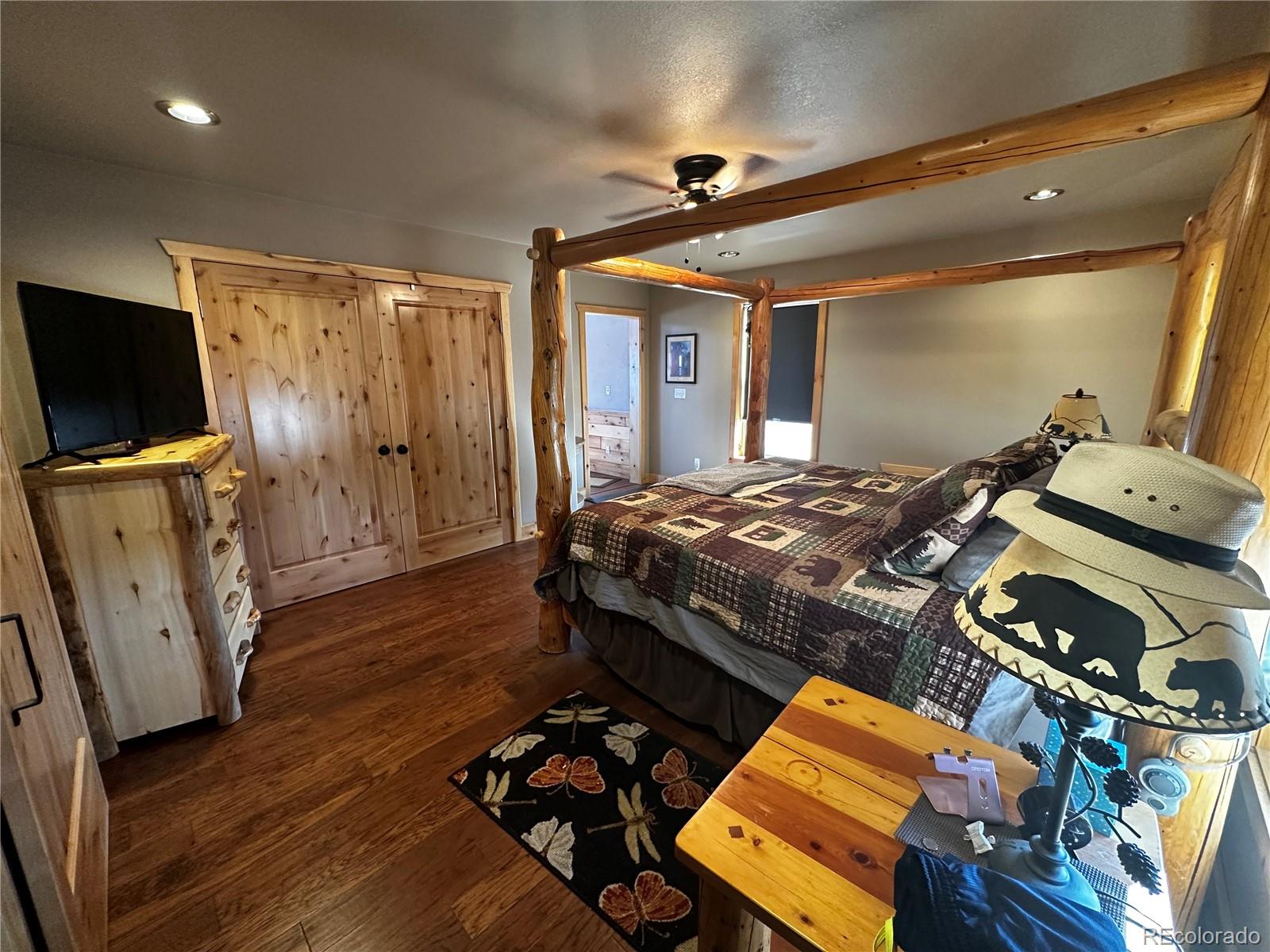 3744 Icehouse Road Fort Garland, CO 81133 - Photo 30 of 48 a bedroom with a bed and wooden floor