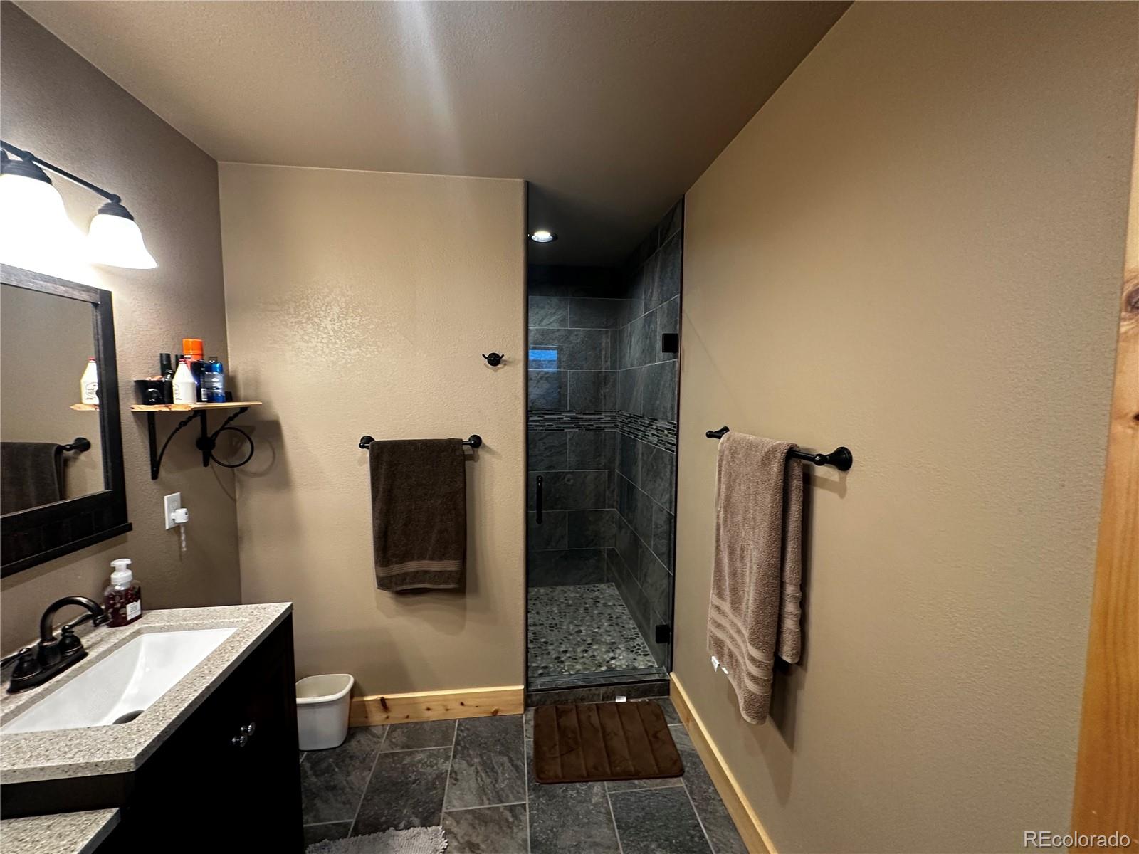 3744 Icehouse Road Fort Garland, CO 81133 - Photo 31 of 48 a bathroom with a sink a toilet and mirror