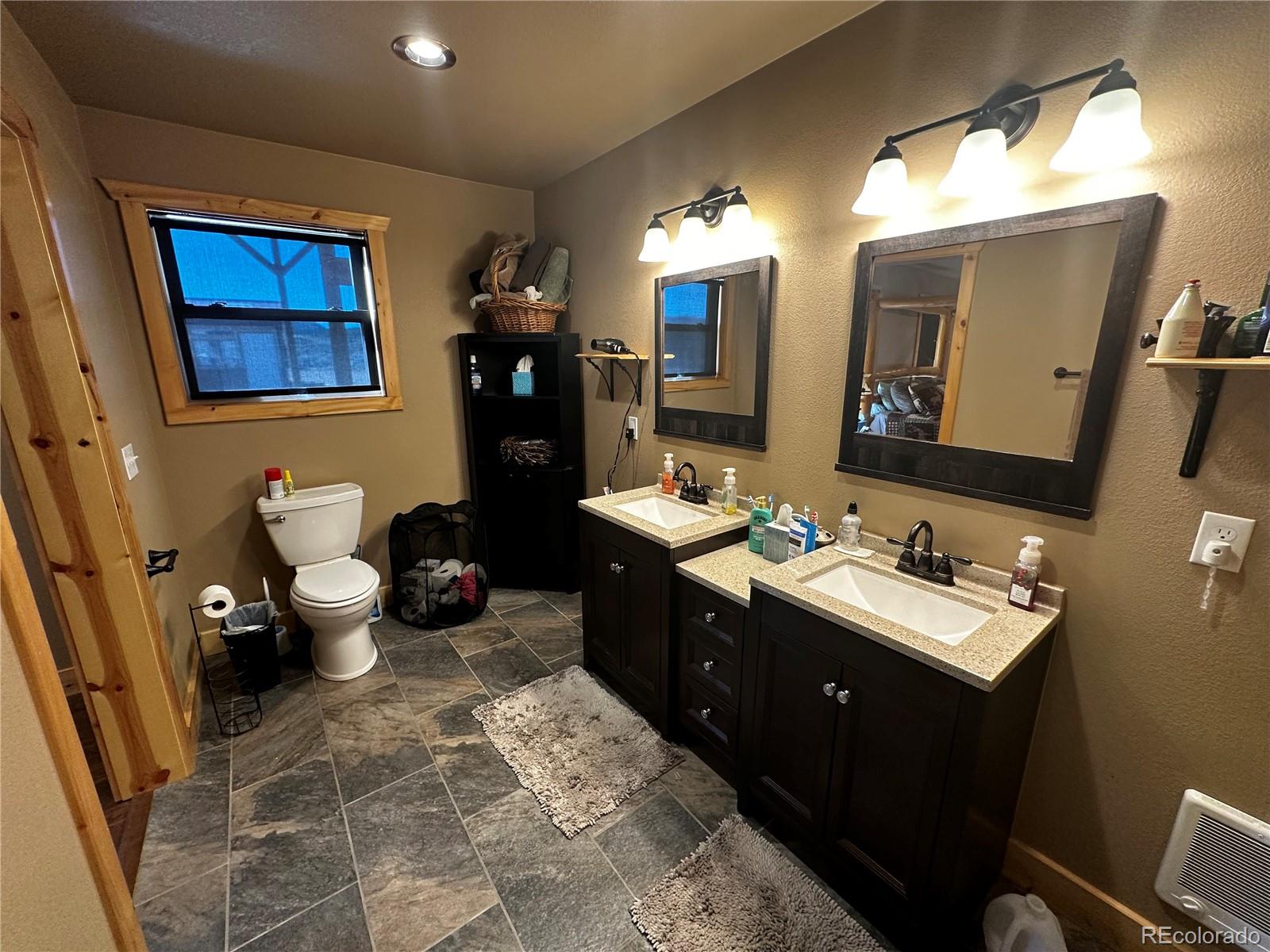 3744 Icehouse Road Fort Garland, CO 81133 - Photo 33 of 48 a bathroom with a toilet sink and mirror