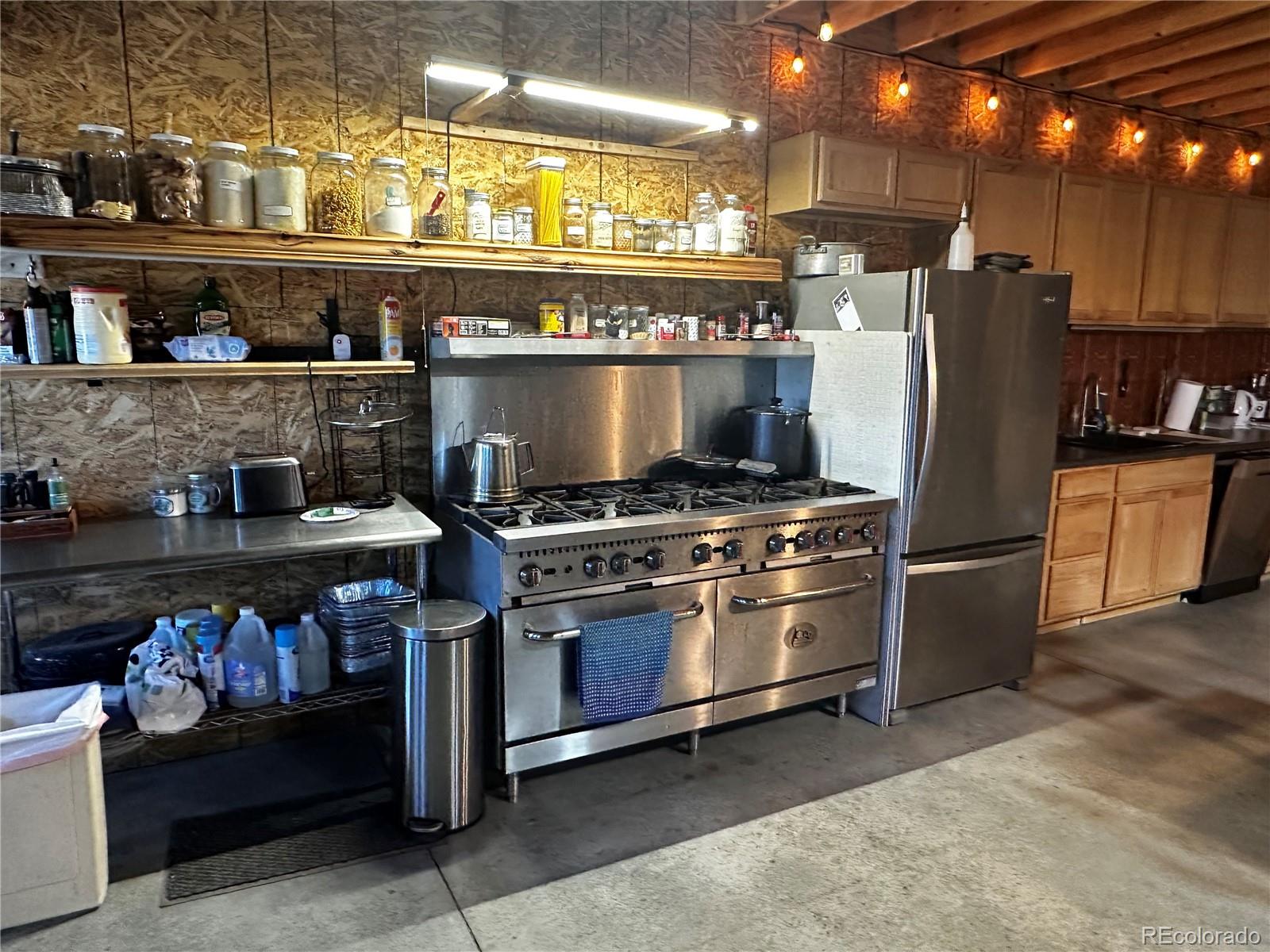 3744 Icehouse Road Fort Garland, CO 81133 - Photo 42 of 48 a kitchen with stainless steel appliances granite countertop a stove and a refrigerator