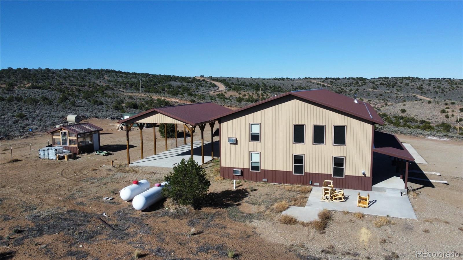 3744 Icehouse Road Fort Garland, CO 81133 - Photo 7 of 48 a view of a white house with a yard
