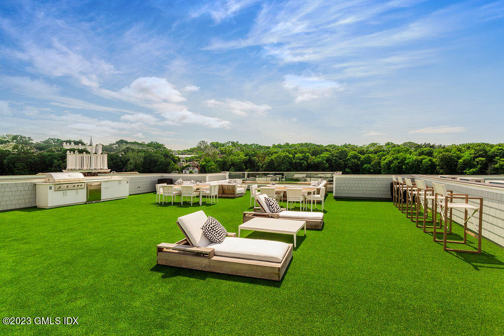 89 River Road, Unit 203 Cos Cob, CT 06807 - Photo 25 of 26 a view of a garden with patio