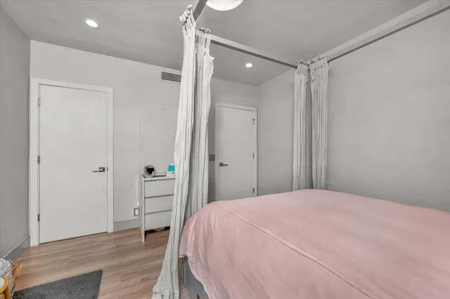 a bedroom with a bed and a dresser