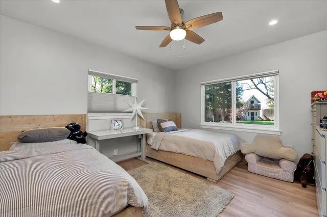 a bathroom with a granite countertop sink a toilet a mirror and shower