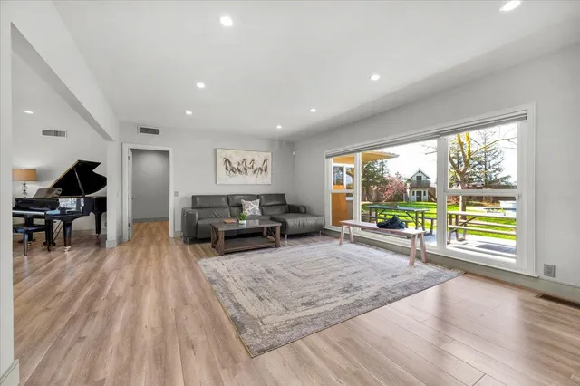 a view of a house with backyard sitting area and garden