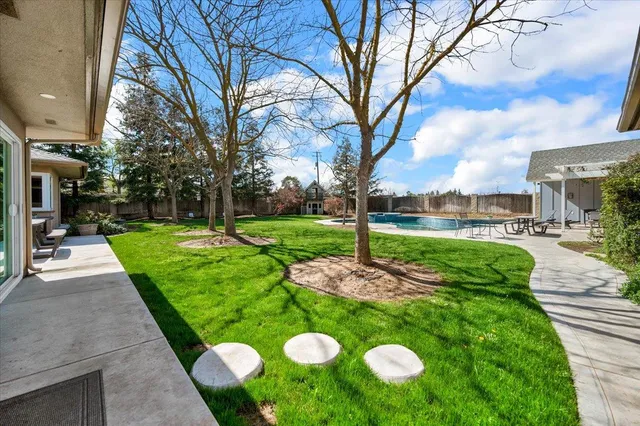 a view of outdoor space with garden and trees