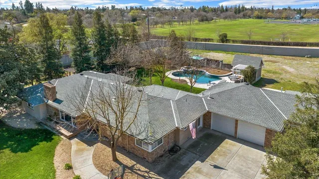 a view of a house with swimming pool and patio