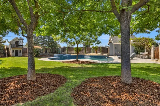 a view of swimming pool and trees in the background