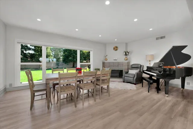 a kitchen with stainless steel appliances granite countertop a kitchen island a stove a sink and a refrigerator