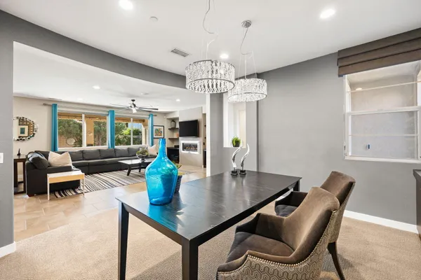 a living room with stainless steel appliances kitchen island granite countertop furniture and a view of living room