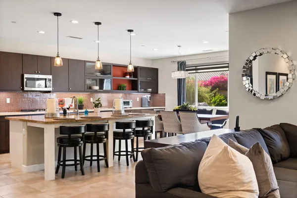 a large kitchen with stainless steel appliances granite countertop a lot of counter space and a sink