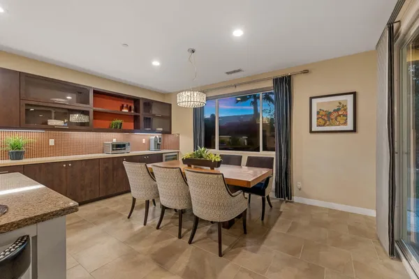 a bedroom with a bed a flat screen tv and a window