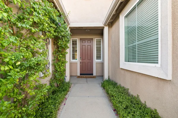 a living room with furniture a large window and a flat screen tv