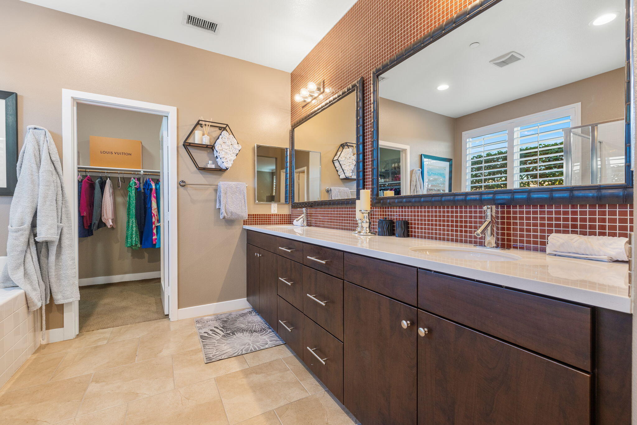 41371 Doyle Street Indio, CA 92203 - Photo 36 of 77 a spacious bathroom with a sink and a mirror
