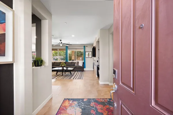 a living room with furniture a rug and a flat screen tv
