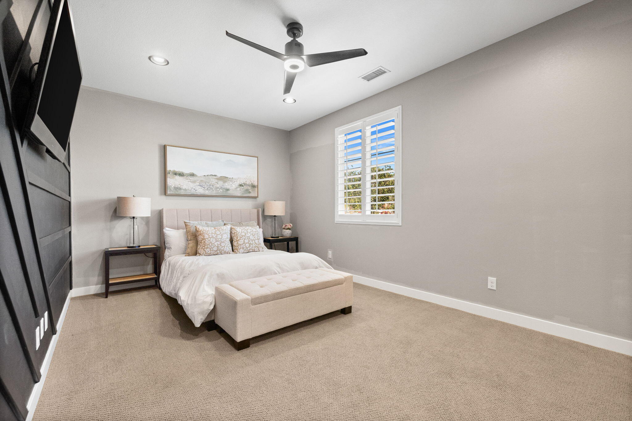 41371 Doyle Street Indio, CA 92203 - Photo 49 of 77 a bedroom with a bed a couch and a flat tv screen on the dresser