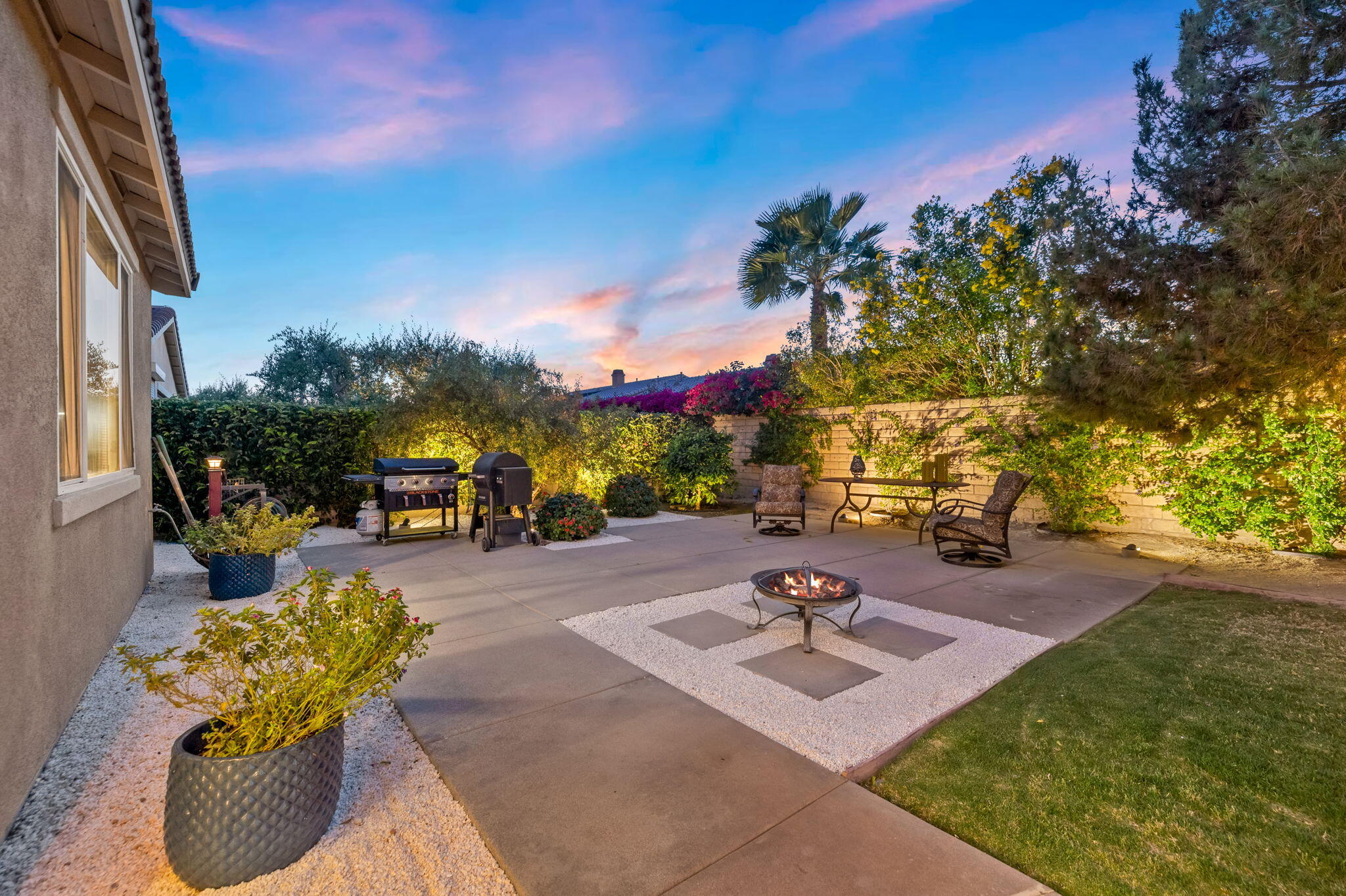 41371 Doyle Street Indio, CA 92203 - Photo 55 of 77 a view of a swimming pool with a patio and a yard