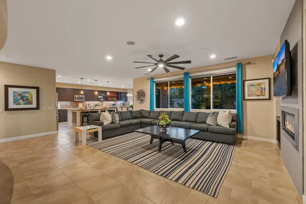 a living room with furniture a fireplace and a flat screen tv
