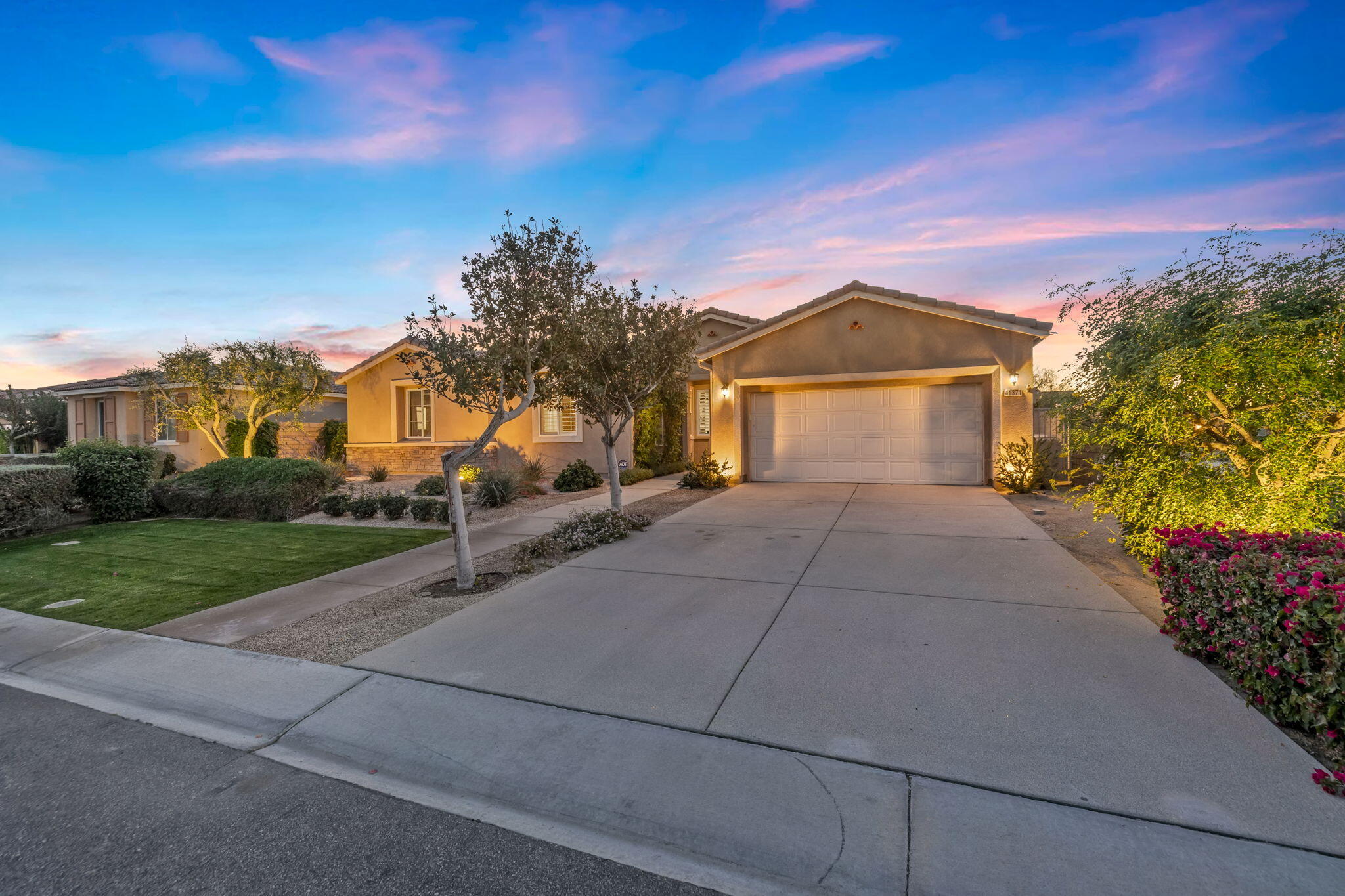 41371 Doyle Street Indio, CA 92203 - Photo 61 of 77 a front view of a house with a yard and garage