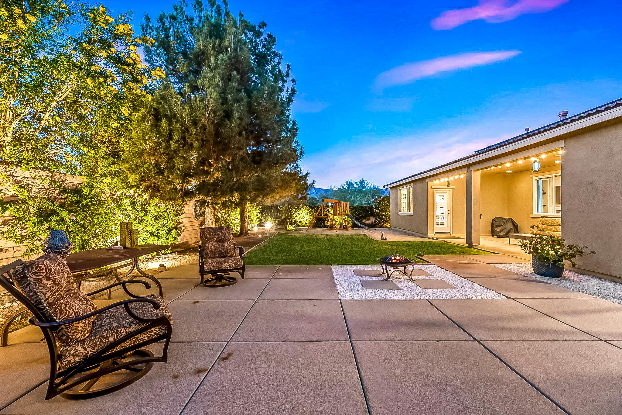 41371 Doyle Street Indio, CA 92203 - Photo 65 of 77 a view of a patio with dining table and chairs with wooden fence