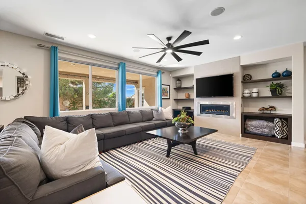 a living room with furniture and a view of kitchen