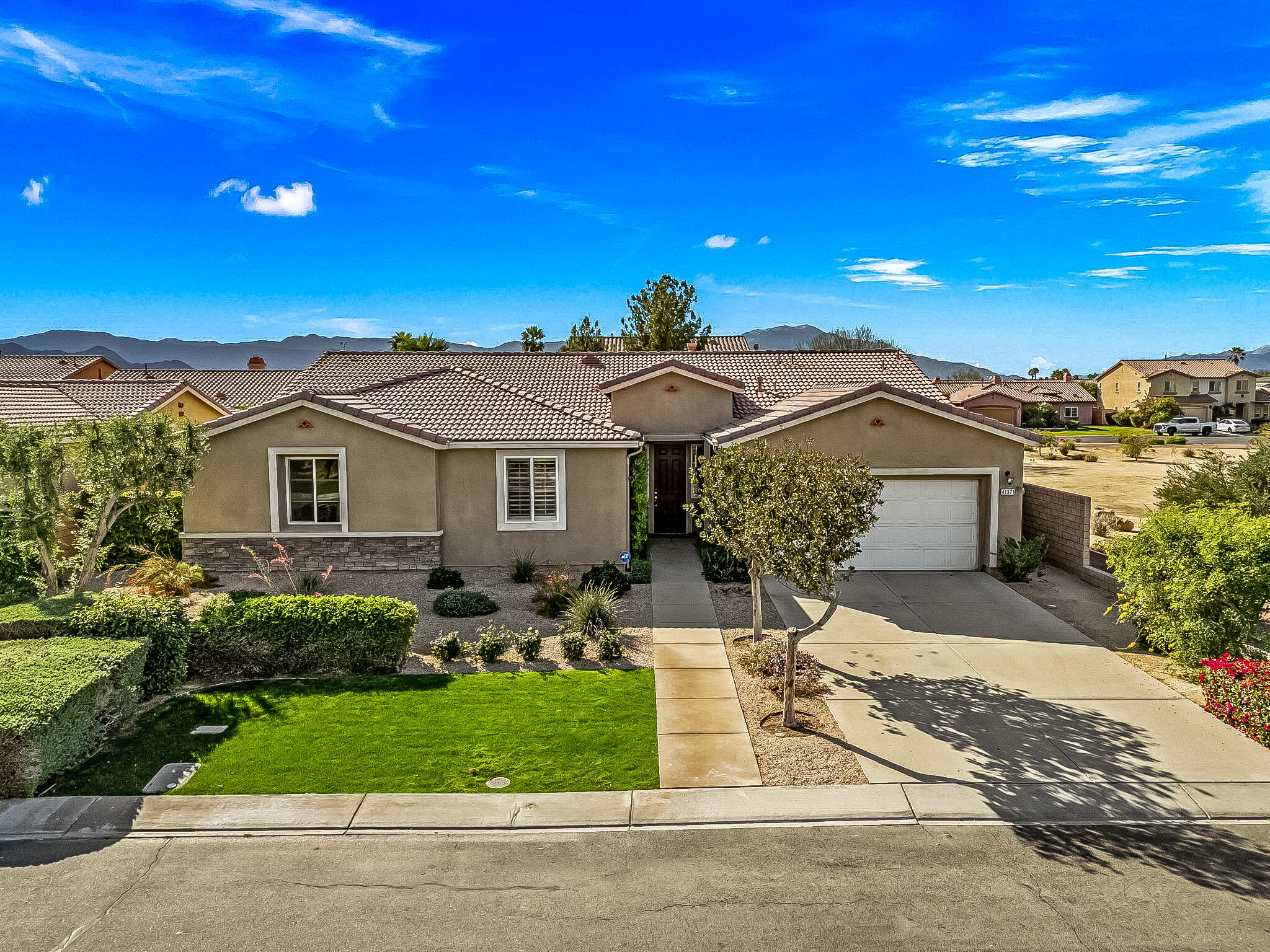 41371 Doyle Street Indio, CA 92203 - Photo 77 of 77 a front view of a house with a garden