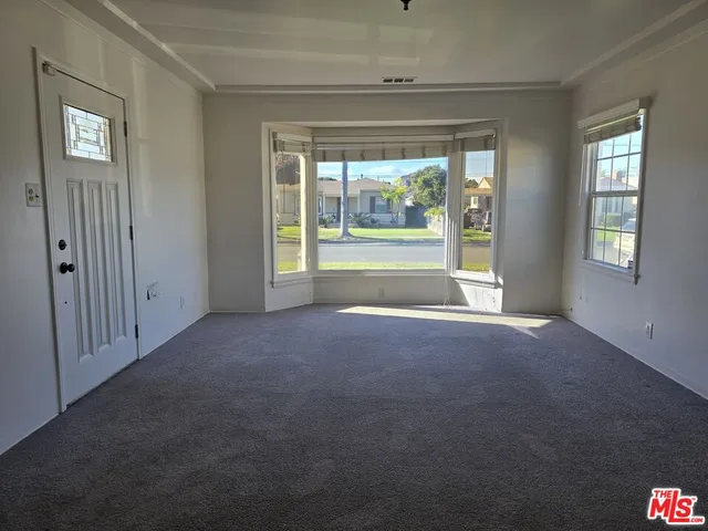 a view of livingroom with furniture wooden floor and front door