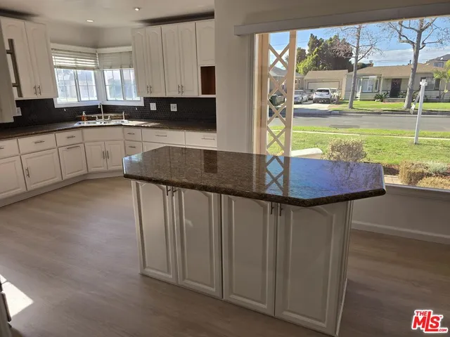 a kitchen with stainless steel appliances granite countertop a sink and cabinets