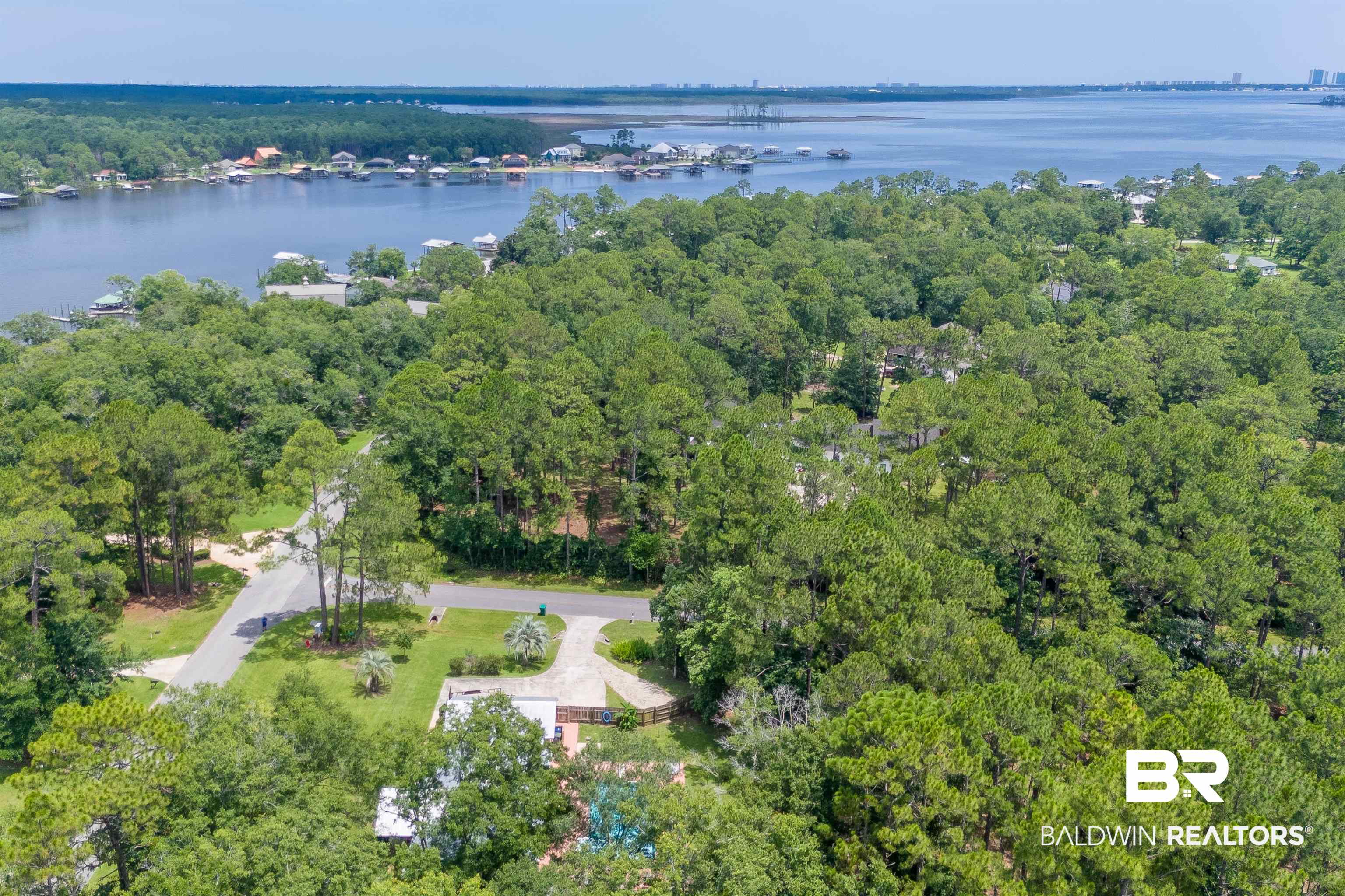 24551 Wolf Bay Drive Foley, AL 36535 - Photo 57 of 59 Aerial overview of property's location with a large body of water and a heavily wooded area