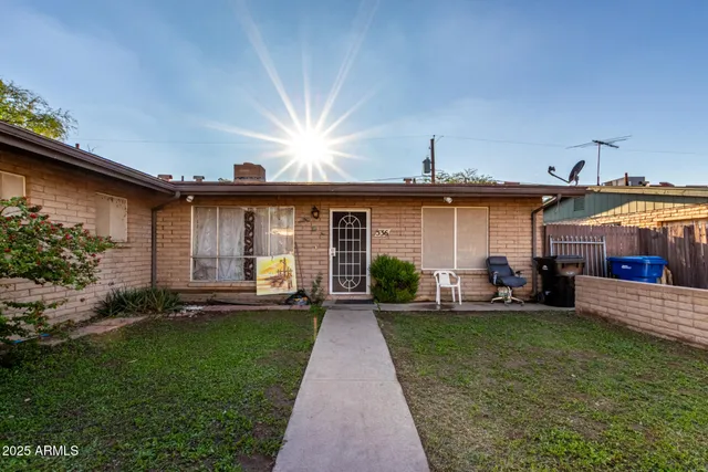 a front view of a house with a yard and porch