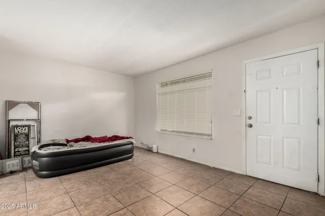 a view of kitchen with refrigerator and cabinets
