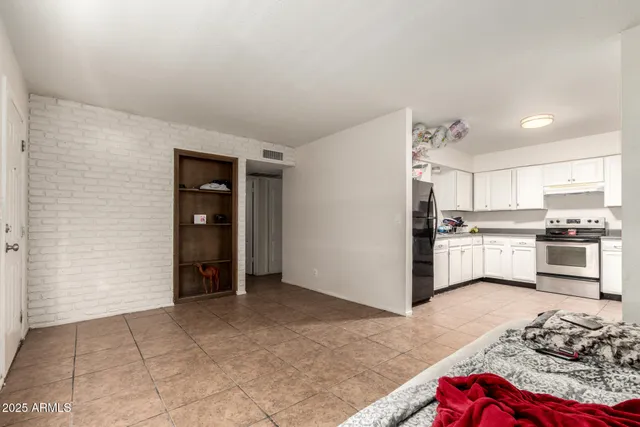 a kitchen with granite countertop white cabinets and stainless steel appliances