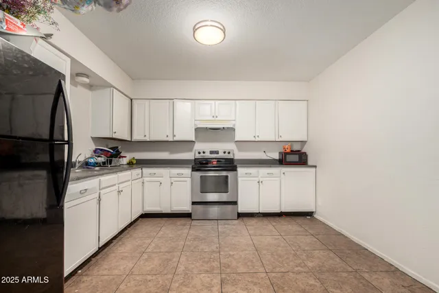 a kitchen with granite countertop cabinets and white appliances