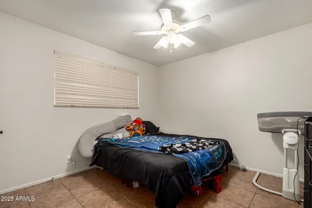 a bedroom with a bed and a mirror