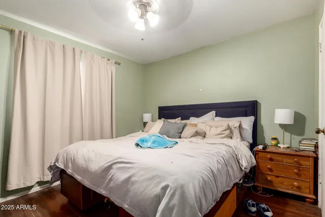 a living room with furniture a piano and wooden floor