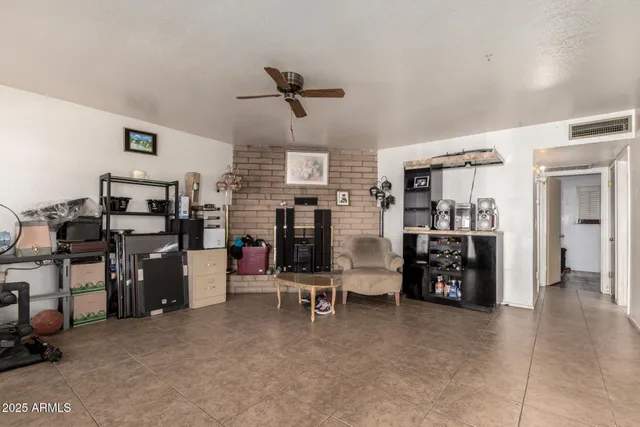 a view of a dining room with furniture a chandelier and window
