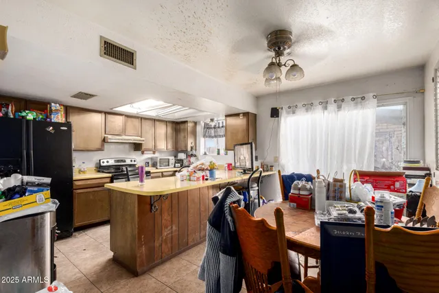 a kitchen with a sink appliances and cabinets