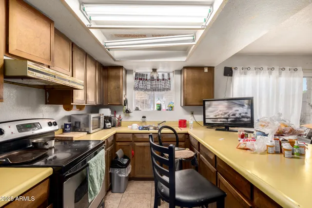 a view of a room with gym equipment and a window