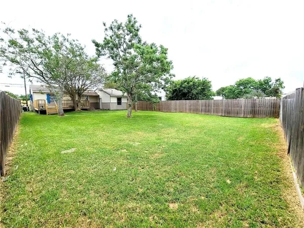 a view of a field of grass and trees